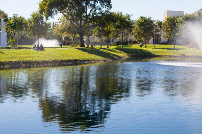 Students on FIU campus by the water