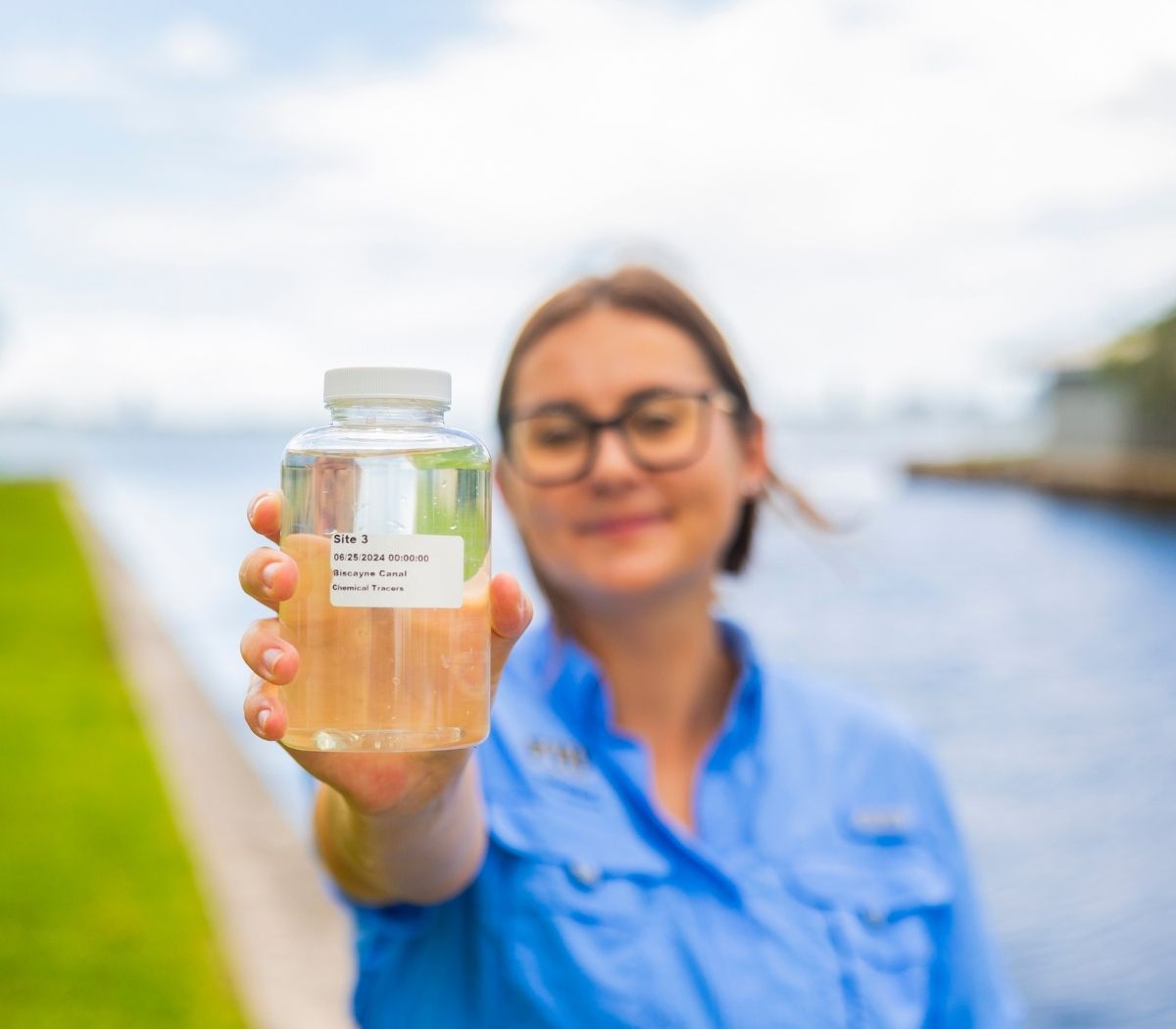 FIU scientist holding water sample