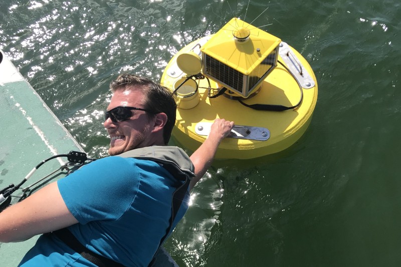 Bradley Schonhoff deploys a monitoring buoy near BBC
