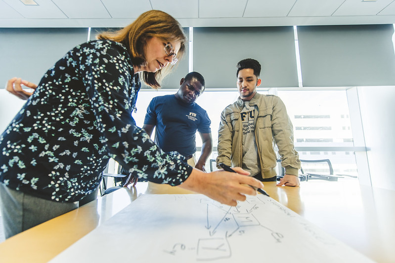 Professor teaches students in biostatistics class